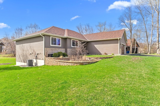rear view of property with a lawn, driveway, a garage, brick siding, and roof with shingles