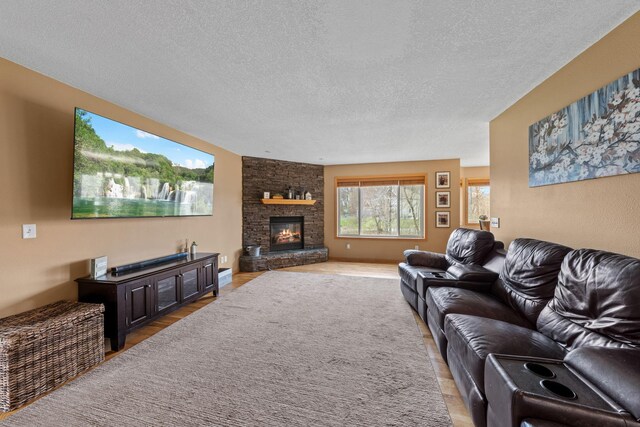 19390 Queen Cir NW, Elk River, MN 55330 - living area with light wood finished floors, a textured ceiling, and a fireplace