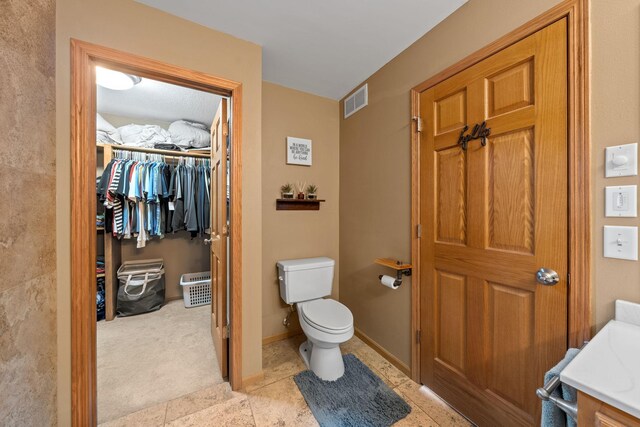 19390 Queen Cir NW, Elk River, MN 55330 - bathroom featuring toilet, tile patterned flooring, and a walk in closet