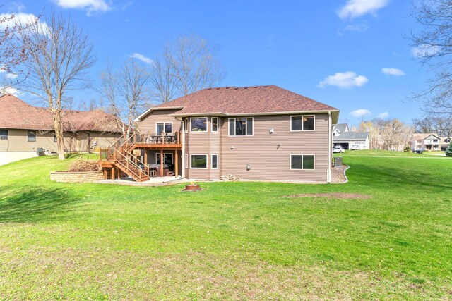 19390 Queen Cir NW, Elk River, MN 55330 - back of property with stairway, a wooden deck, a lawn, and roof with shingles