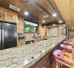 19390 Queen Cir NW, Elk River, MN 55330 - kitchen featuring wood ceiling, light stone counters, refrigerator, a peninsula, and light brown cabinets