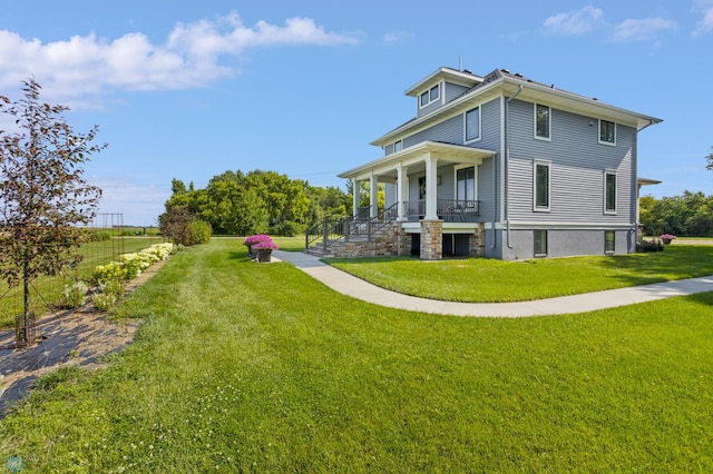 9730 177th Ave SE, Fairmount, ND 58030 - back of property with stairway, a lawn, and covered porch