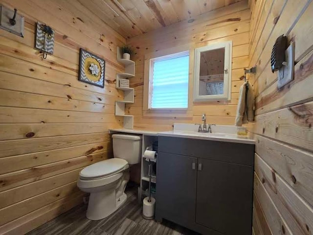 50967 Wymer Lake Trl, Hobart Twp, MN 56544 - bathroom with wooden walls, toilet, vanity, wood ceiling, and wood finished floors