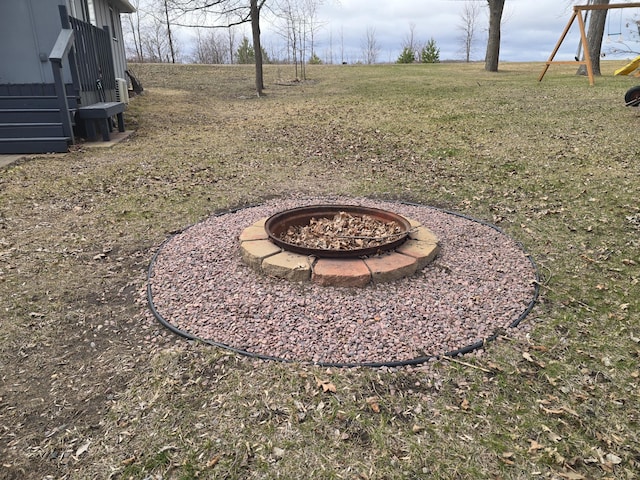 50967 Wymer Lake Trl, Hobart Twp, MN 56544 - view of grassy yard with a fire pit