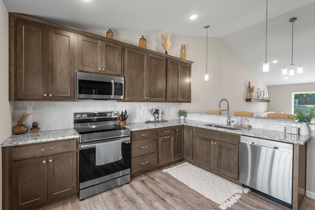 5928 Th St W, Lakeville, MN 55044 - kitchen featuring stainless steel appliances, a sink, a peninsula, vaulted ceiling, and dark brown cabinets