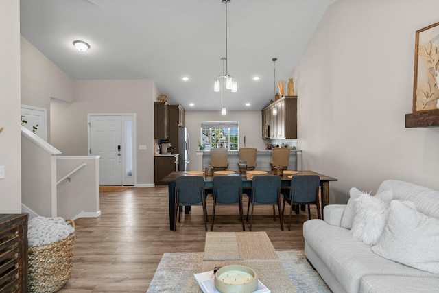 5928 Th St W, Lakeville, MN 55044 - living area with lofted ceiling, light wood-style flooring, baseboards, stairs, and recessed lighting