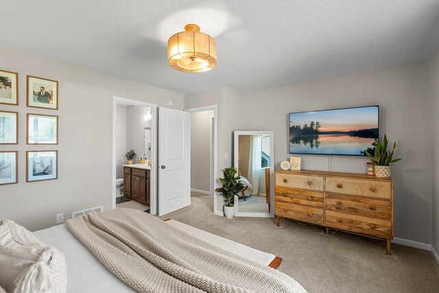 5928 Th St W, Lakeville, MN 55044 - bedroom with light carpet, baseboards, and ensuite bath