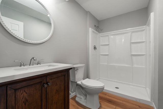 5928 Th St W, Lakeville, MN 55044 - full bathroom featuring toilet, wood finished floors, a shower, and vanity