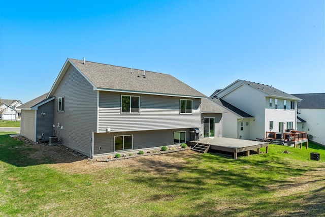 5928 Th St W, Lakeville, MN 55044 - rear view of property with central air condition unit, a deck, a lawn, and a shingled roof