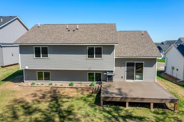 5928 Th St W, Lakeville, MN 55044 - rear view of house with a shingled roof, a wooden deck, and a yard
