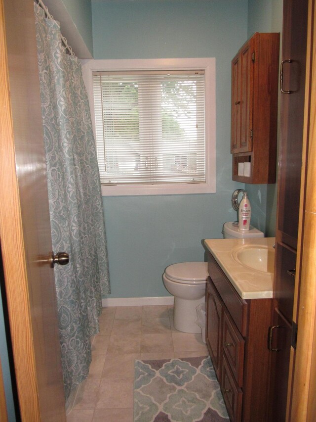 218 Lake Ave E, Fulda, MN 56131 - full bathroom featuring vanity, toilet, tile patterned floors, and baseboards