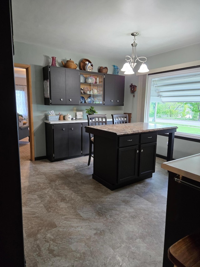 218 Lake Ave E, Fulda, MN 56131 - kitchen featuring a chandelier, hanging light fixtures, open shelves, light countertops, and a kitchen island