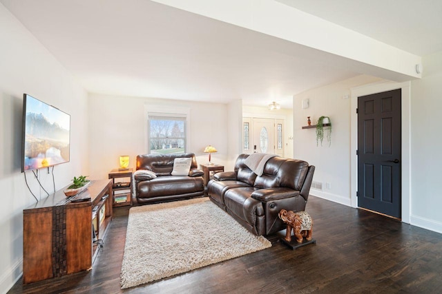 living room featuring baseboards and wood finished floors