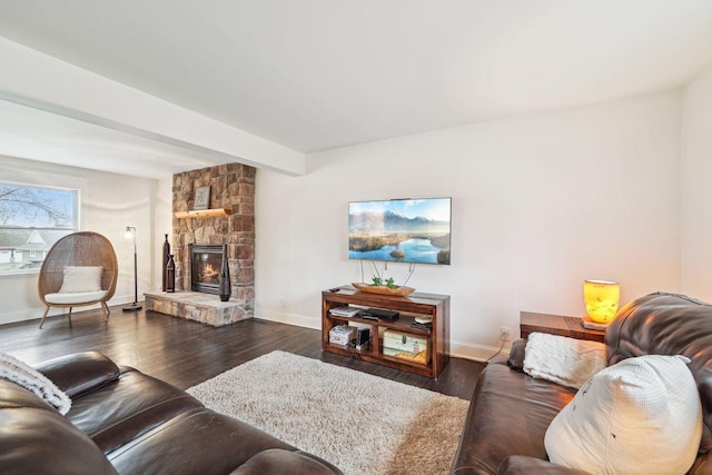 living room with baseboards, dark wood-type flooring, and a fireplace