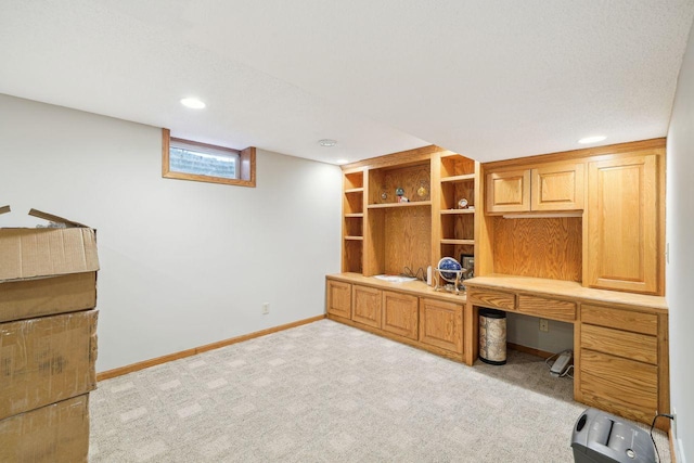 unfurnished office with light carpet, baseboards, built in study area, and recessed lighting