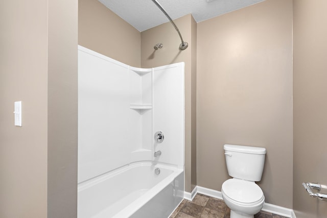 full bathroom featuring baseboards, a textured ceiling, shower / tub combination, and toilet