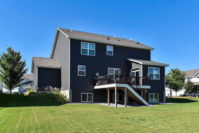 rear view of property with a wooden deck, stairway, and a yard