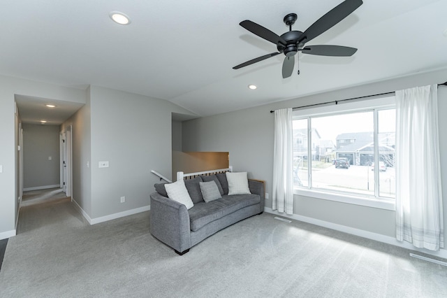 unfurnished living room with baseboards, carpet, and ceiling fan
