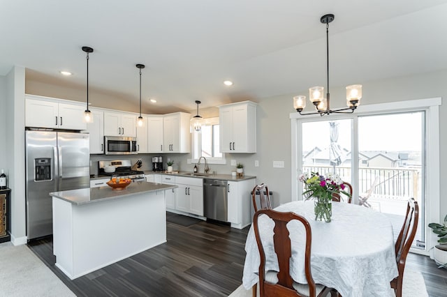 kitchen featuring dark wood-type flooring, white cabinets, appliances with stainless steel finishes, and a sink