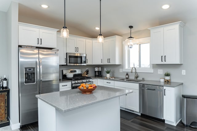 kitchen featuring dark wood-type flooring, white cabinetry, stainless steel appliances, and a sink