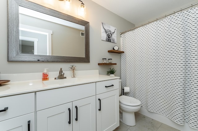 full bath featuring toilet, vanity, and visible vents