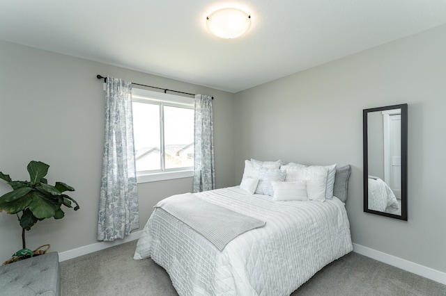 bedroom featuring light carpet and baseboards