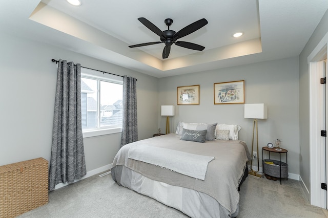 bedroom featuring baseboards, a tray ceiling, carpet, and recessed lighting