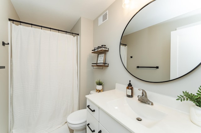 bathroom with visible vents, vanity, and toilet