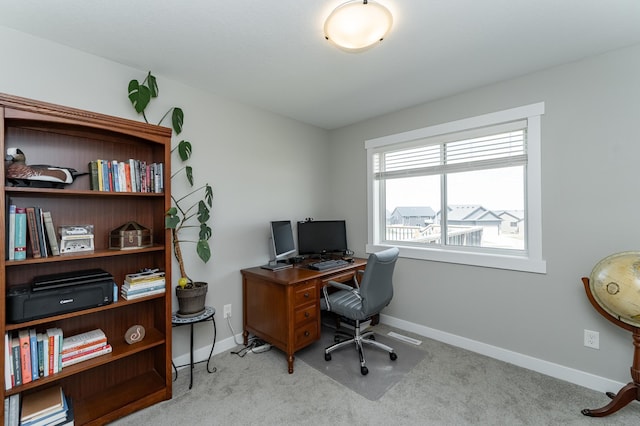office featuring light carpet and baseboards