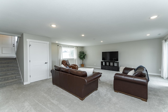 living room featuring carpet flooring, recessed lighting, and stairway