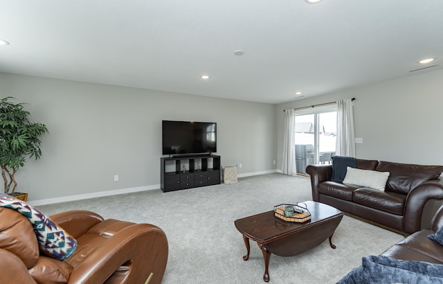 carpeted living area featuring recessed lighting and baseboards