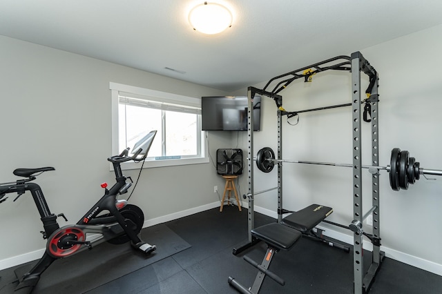 workout area featuring baseboards