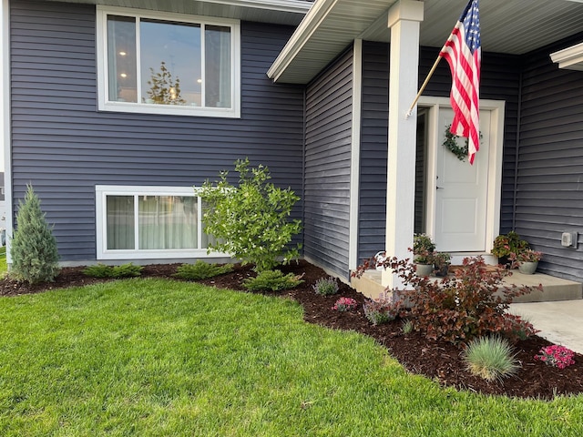 entrance to property featuring a yard