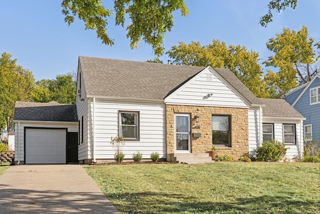 view of front of property with driveway, a shingled roof, a front yard, and a garage