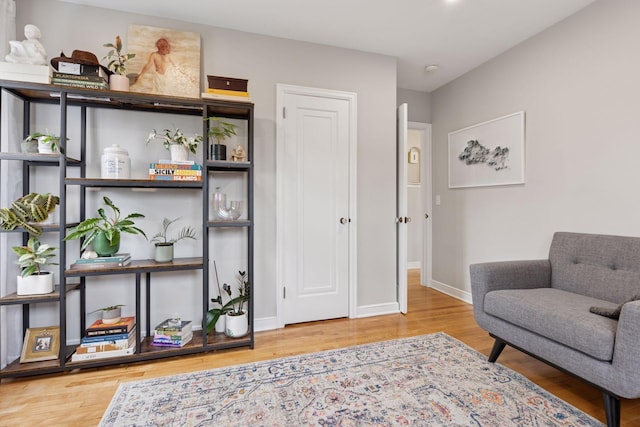 sitting room featuring baseboards and wood finished floors