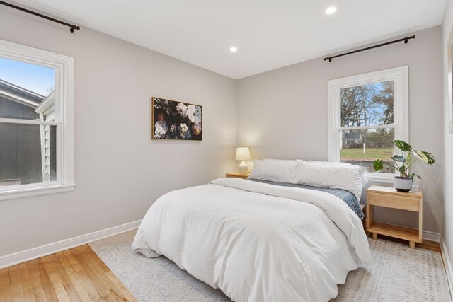 bedroom featuring recessed lighting, baseboards, and light wood finished floors