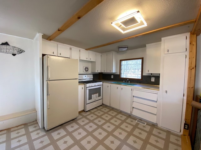 W8108 Vernon Ave, Chicog Twp, WI 54888 - kitchen with light floors, white appliances, a sink, and white cabinetry