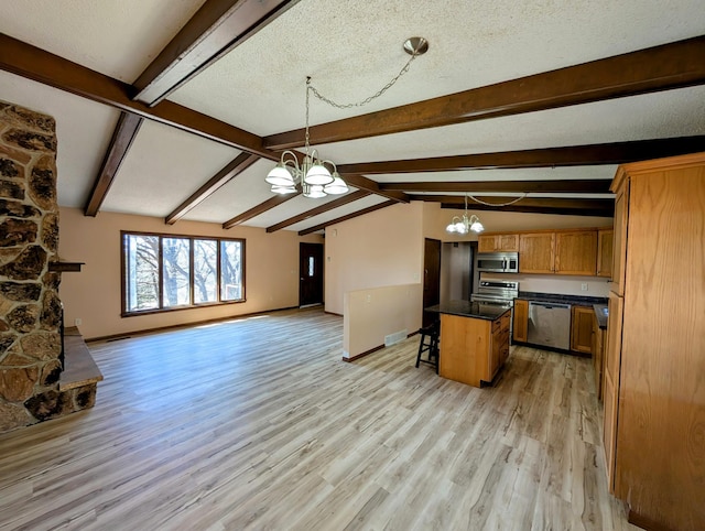 1433 Ridgeview Dr, Montevideo, MN 56265 - kitchen with a chandelier, appliances with stainless steel finishes, open floor plan, dark countertops, and light wood-style flooring