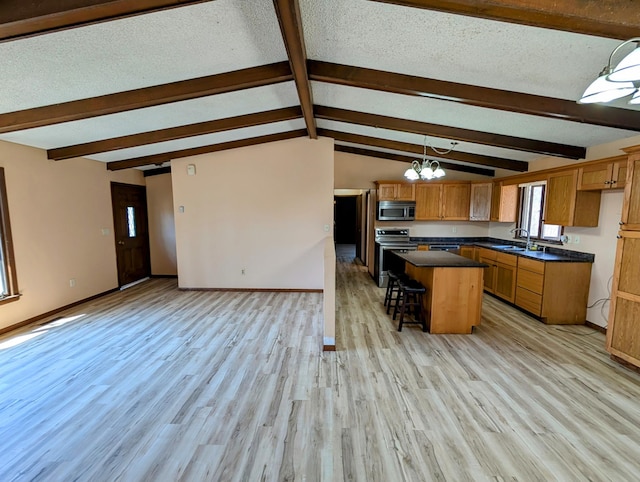 1433 Ridgeview Dr, Montevideo, MN 56265 - kitchen featuring stainless steel appliances, light wood-style flooring, a sink, dark countertops, and a breakfast bar