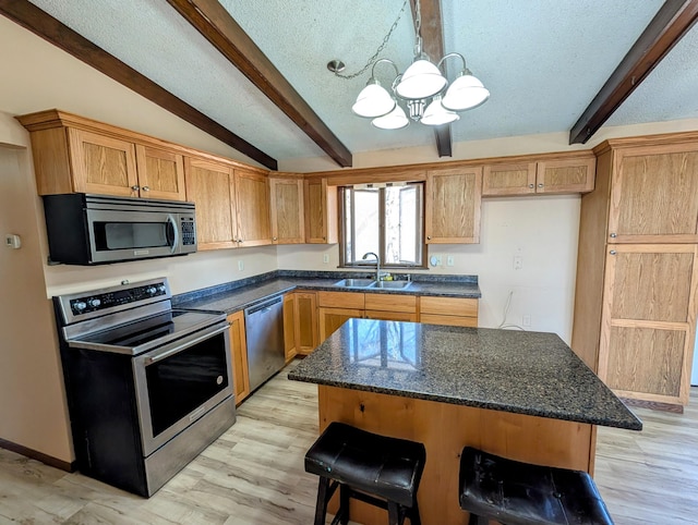 1433 Ridgeview Dr, Montevideo, MN 56265 - kitchen featuring stainless steel appliances, a sink, a chandelier, a breakfast bar, and decorative light fixtures