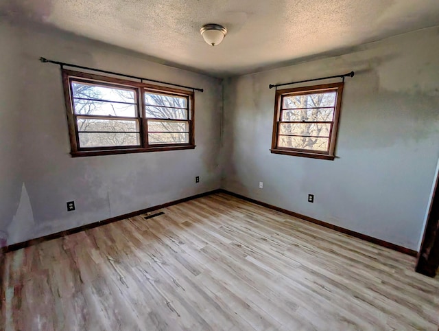 1433 Ridgeview Dr, Montevideo, MN 56265 - spare room with a textured ceiling, wood finished floors, and baseboards