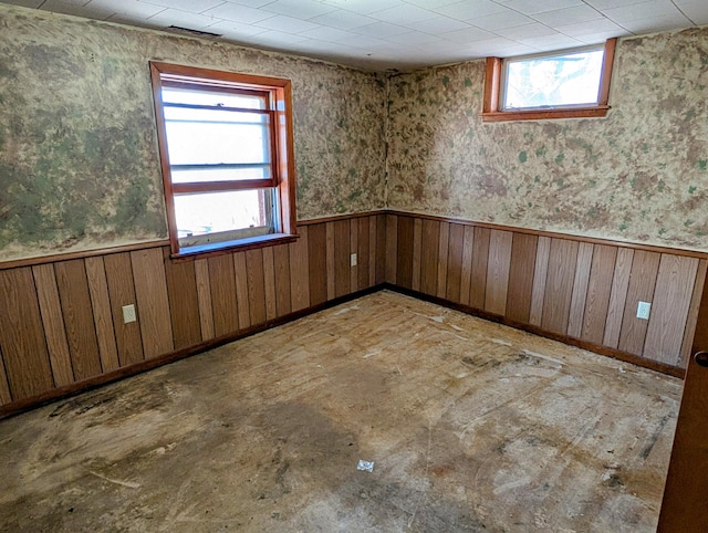 1433 Ridgeview Dr, Montevideo, MN 56265 - unfurnished room featuring plenty of natural light, wainscoting, wooden walls, and wallpapered walls