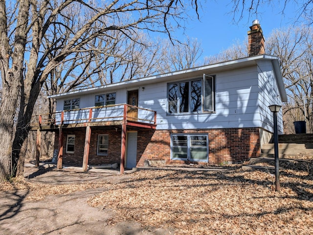 1433 Ridgeview Dr, Montevideo, MN 56265 - back of property featuring a chimney, a deck, and brick siding