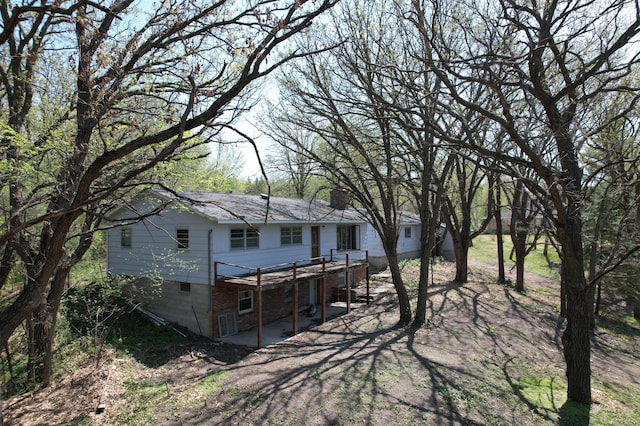 1433 Ridgeview Dr, Montevideo, MN 56265 - rear view of house featuring a chimney, a wooden deck, and a patio area