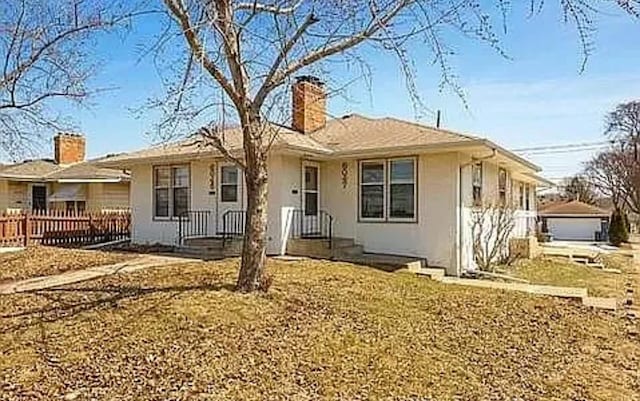 view of front of property with a chimney and stucco siding