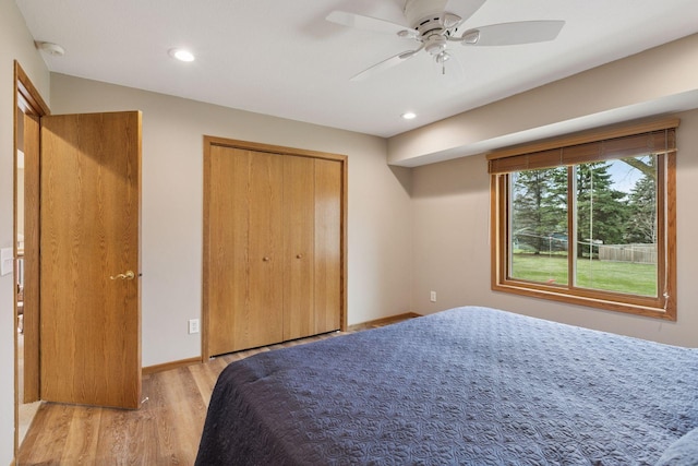 bedroom with a closet, ceiling fan, light wood finished floors, baseboards, and recessed lighting