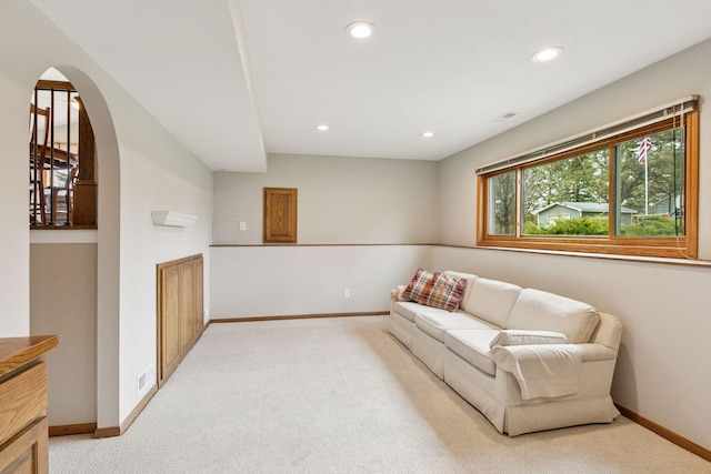 living room featuring baseboards, recessed lighting, and light colored carpet