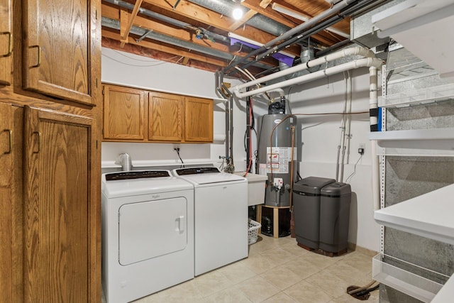 laundry area with a sink, gas water heater, cabinet space, washer and dryer, and light tile patterned floors