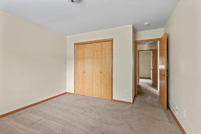 7051 Fox Rd, Baxter, MN 56425 - unfurnished bedroom featuring light carpet, baseboards, and a closet