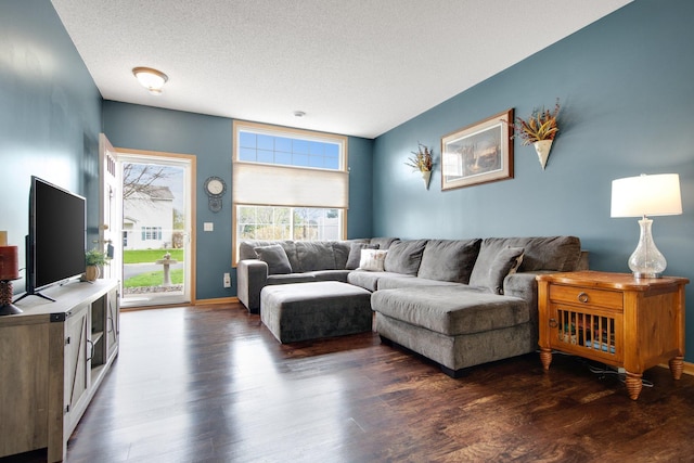living room with dark wood-style floors and a textured ceiling